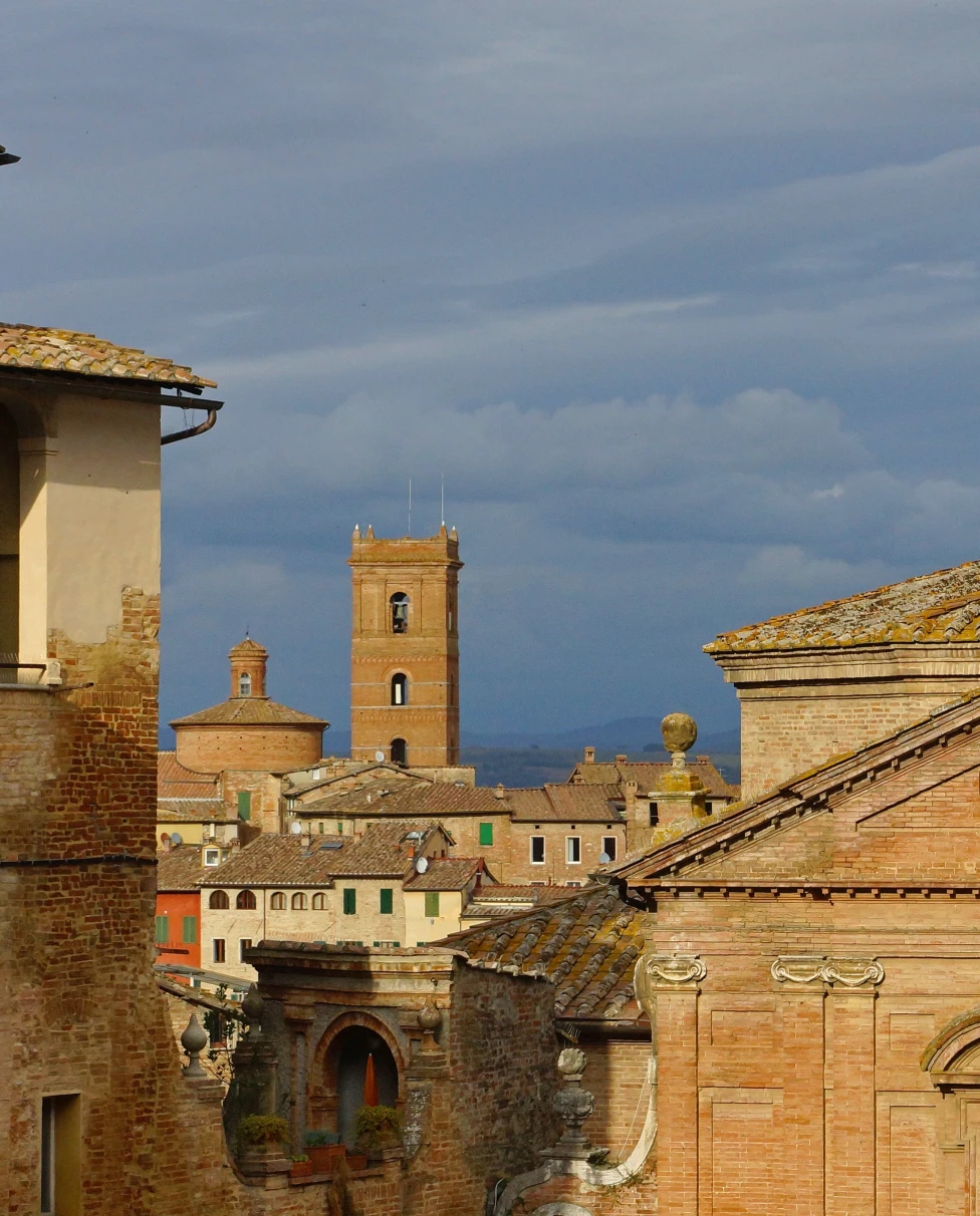 Skyline with tower in old city of Siena, Tuscany in Italy on a cloudy day.