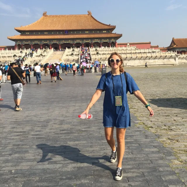 Travel Advisor Catherine Weirick wearing a blue dress in front of a temple.