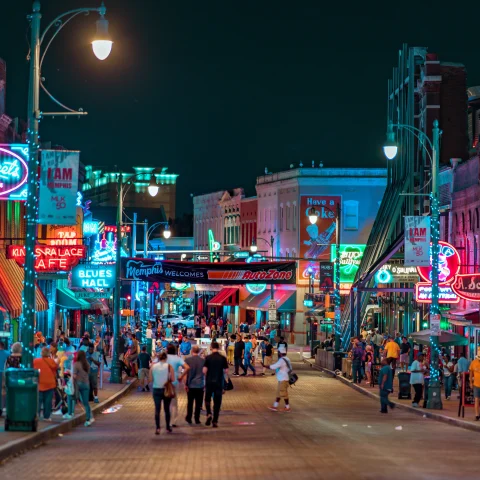 street with people and bright lights during nighttime