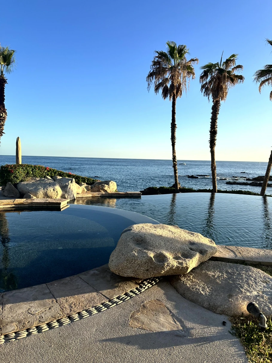 two pools in front of the ocean during daytime