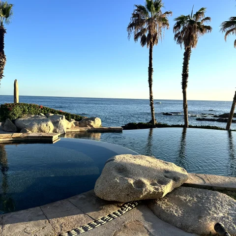 two pools in front of the ocean during daytime