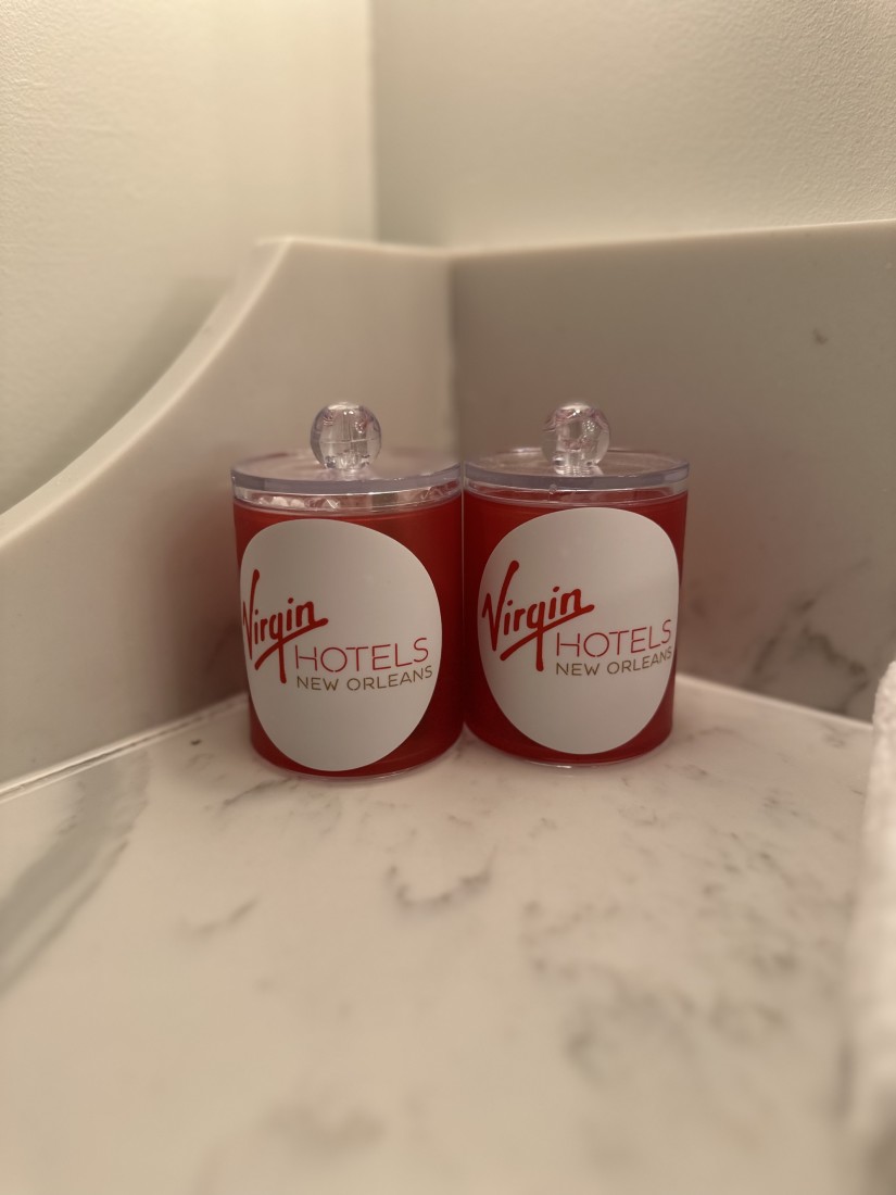 Two small pots in the bathroom with red design showing the Virgin brand