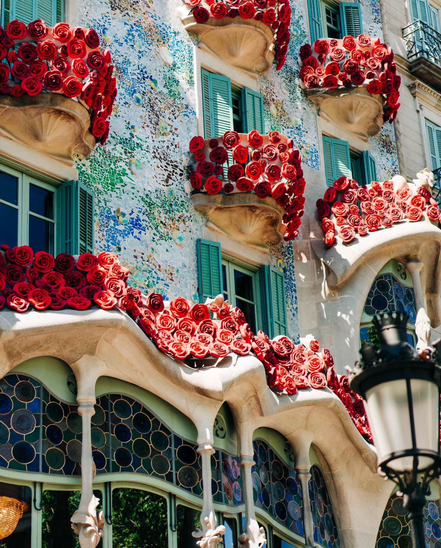 A colorful and tiled facade of one of Gaudi architectural marvels. 