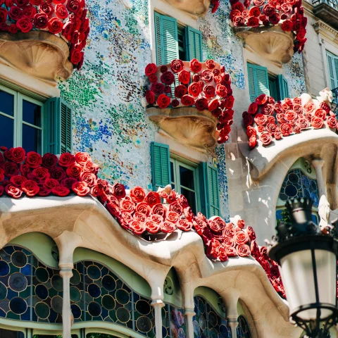 A colorful and tiled facade of one of Gaudi architectural marvels. 