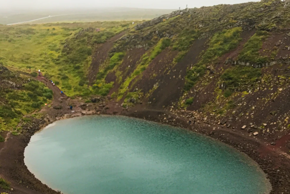 An ovel shaped lake surrounded by mountains