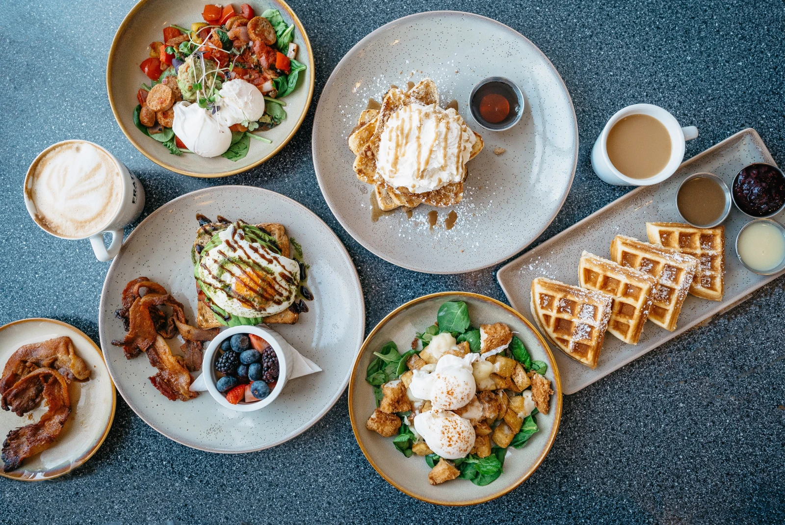 Brunch table scape with waffles, eggs, potatoes and more. 