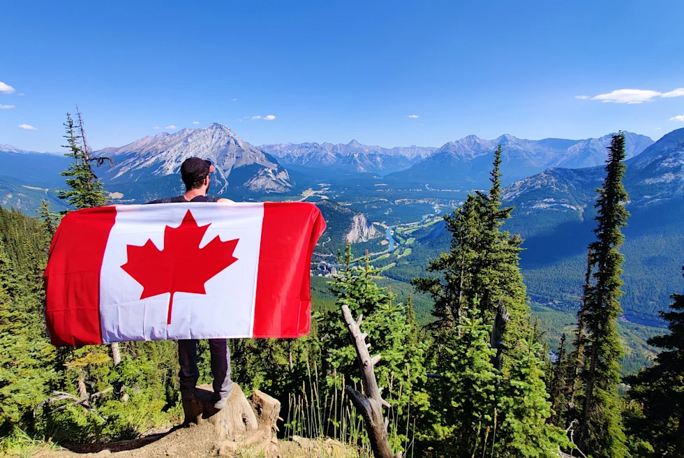 Canadian flag in the mountains.