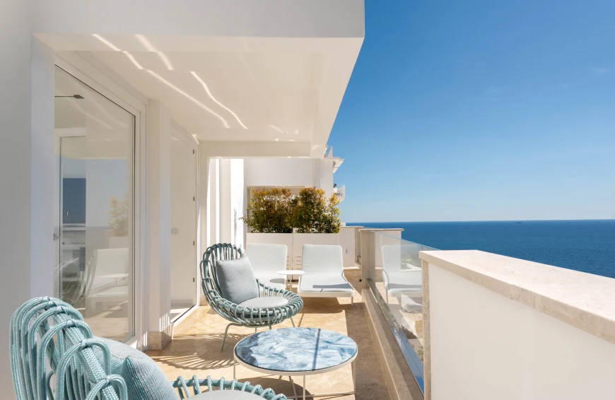 blue chairs on a white oceanside terrace