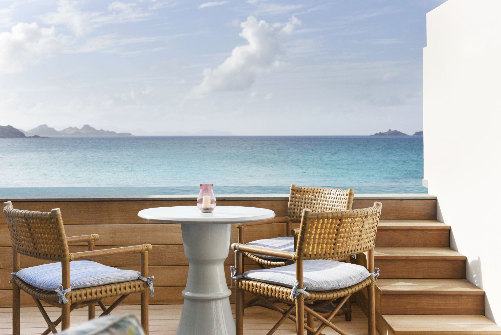 chairs and table overlooking ocean during daytime