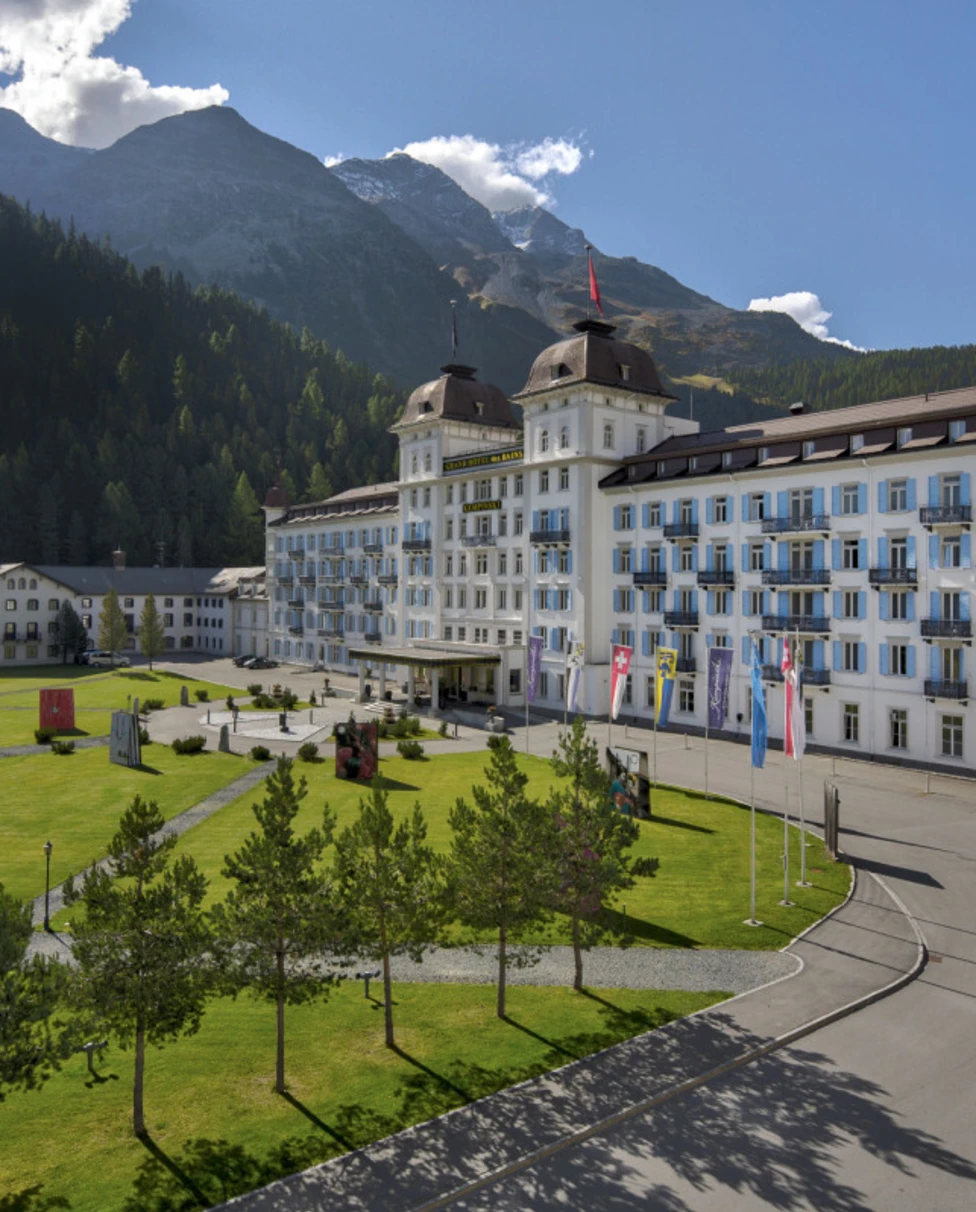 palatial hotel amid a lush mountain landscape
