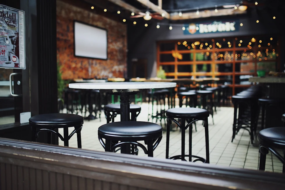 casual bar interior with black stools and tables