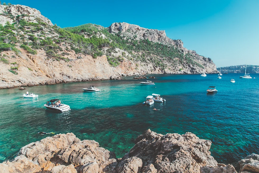 boats in turquoise waters during daytime