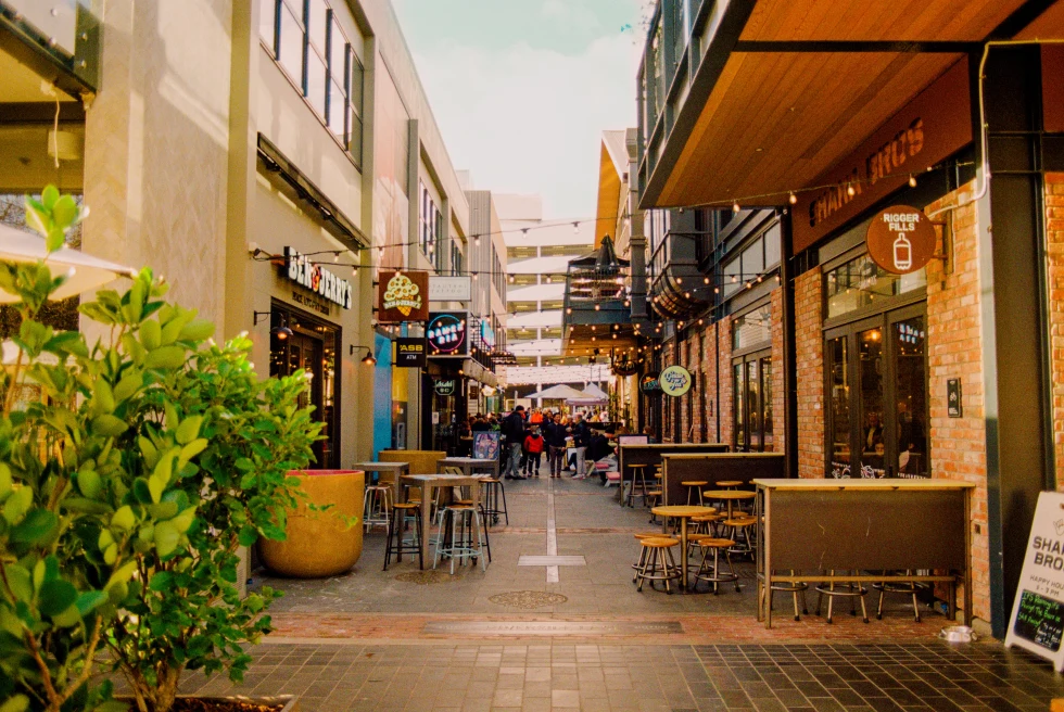 Streets and businesses with tables and hanging lights