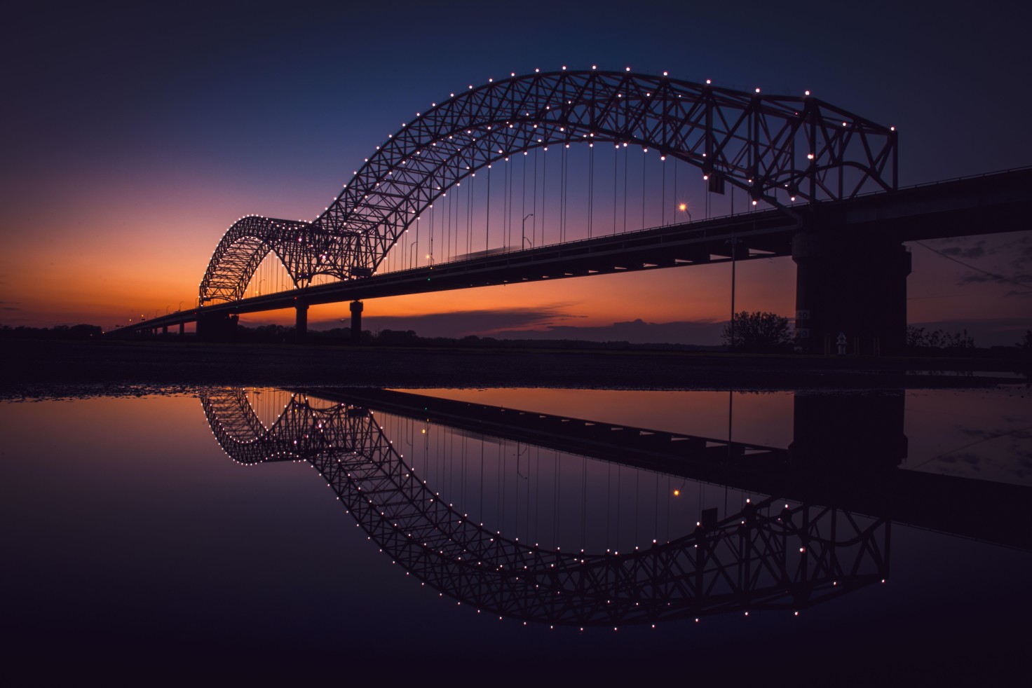 Bridge in Memphis Tennessee with orange sunset in the sky