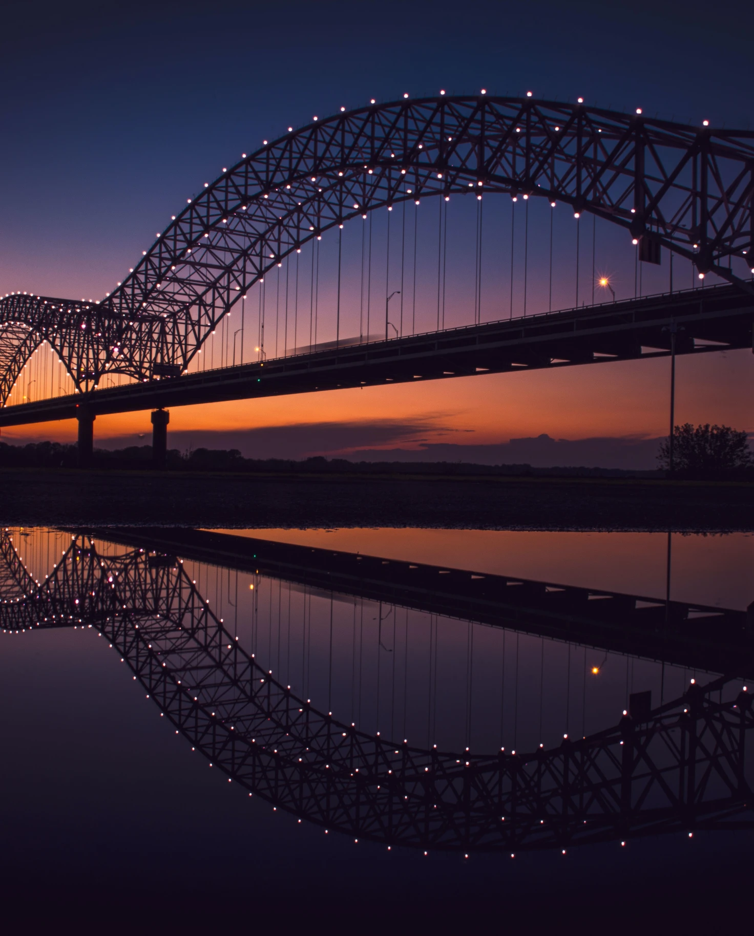 Bridge in Memphis Tennessee with orange sunset in the sky