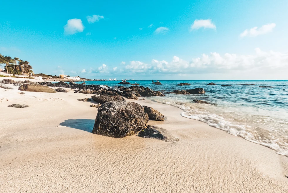 White sand beach and blue ocean with blue skies in Aruba
