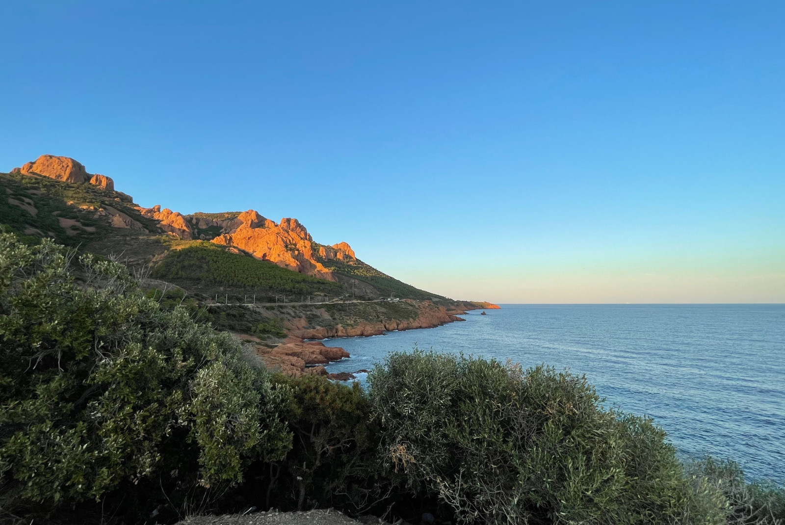 cliff next to body of water during sunset