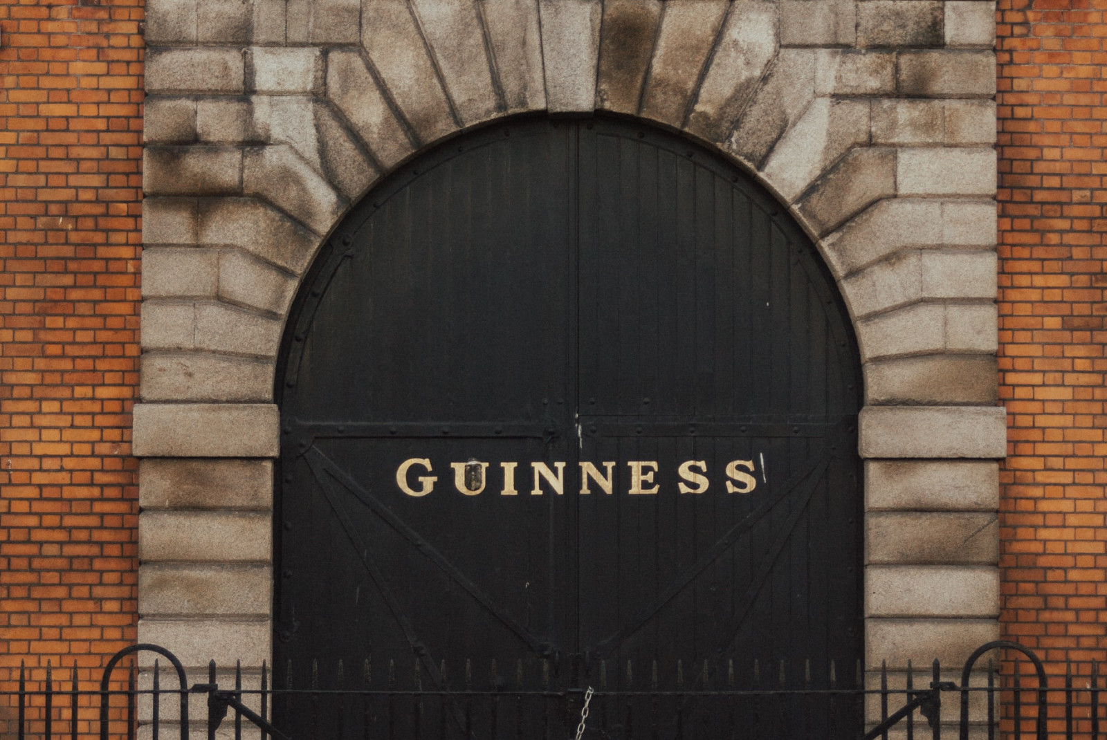 Brick building with gold sign during daytime