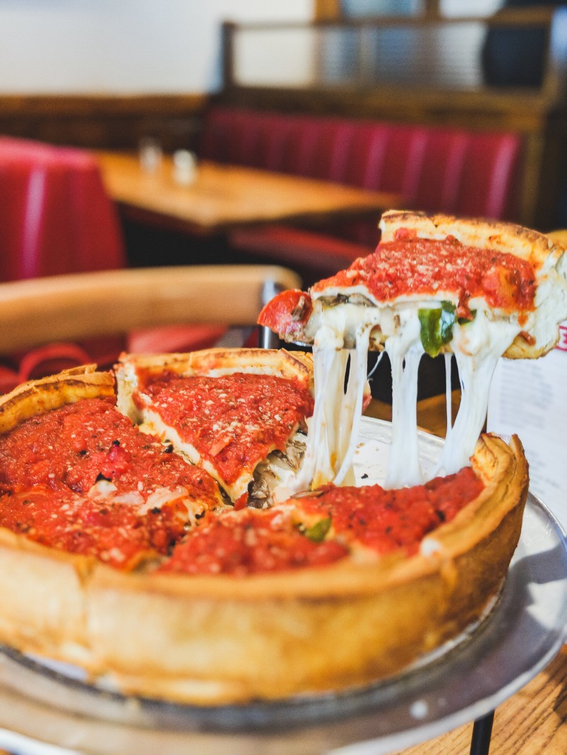 deep dish pizza on a wooden table