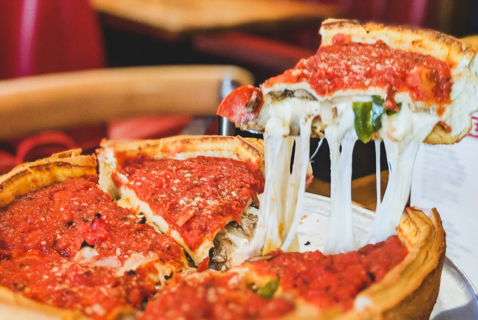 deep dish pizza on a wooden table
