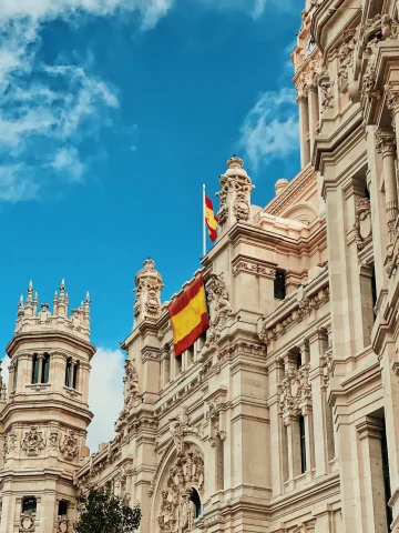 stone palace with the Spanish flag out front