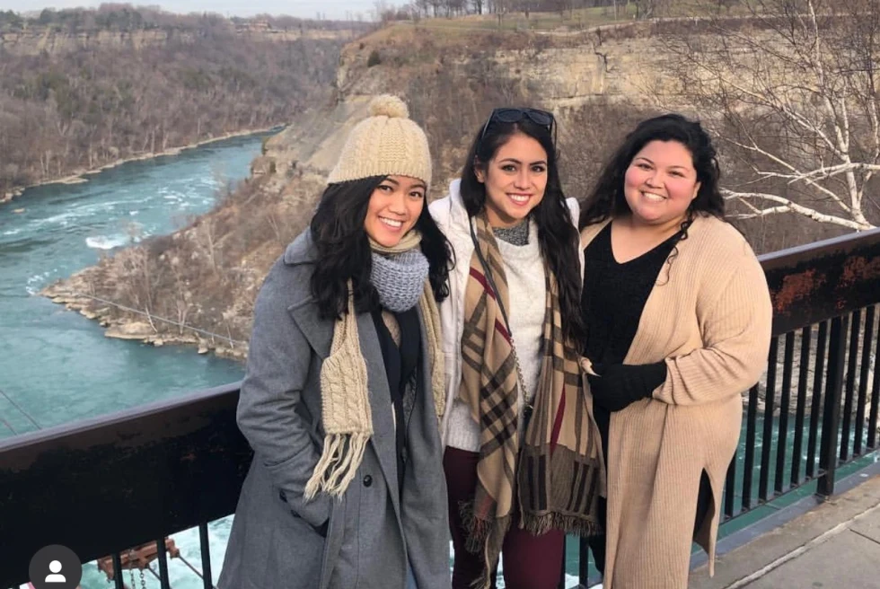 three woman pose at niagra falls