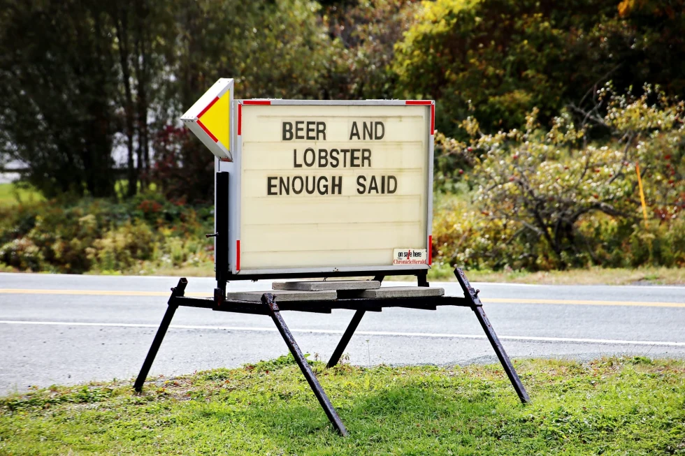 "beer and lobster enough said sign on the side of the street