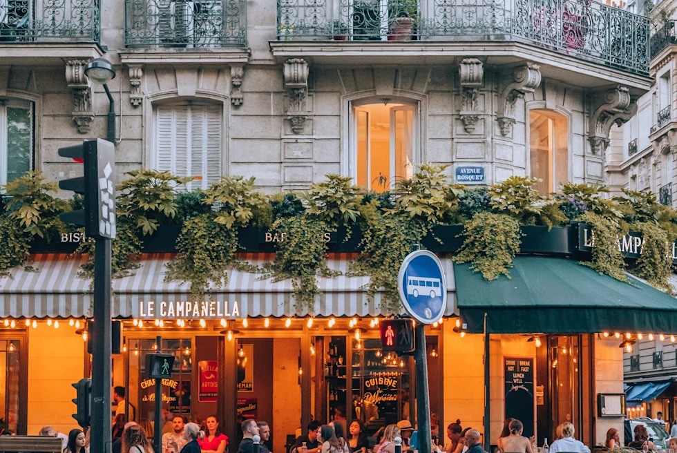 People sitting in a restaurant's outdoor sitting area.