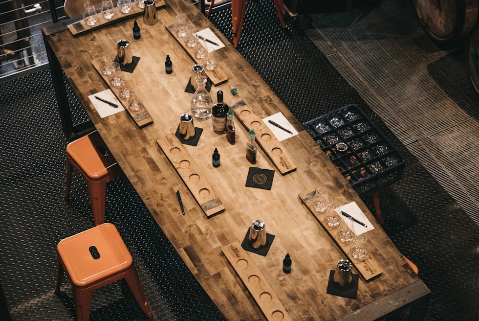 A wooden whiskey tasting room and chairs.