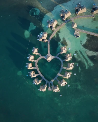 aerial view of a individual resort rooms in the shape of a heart