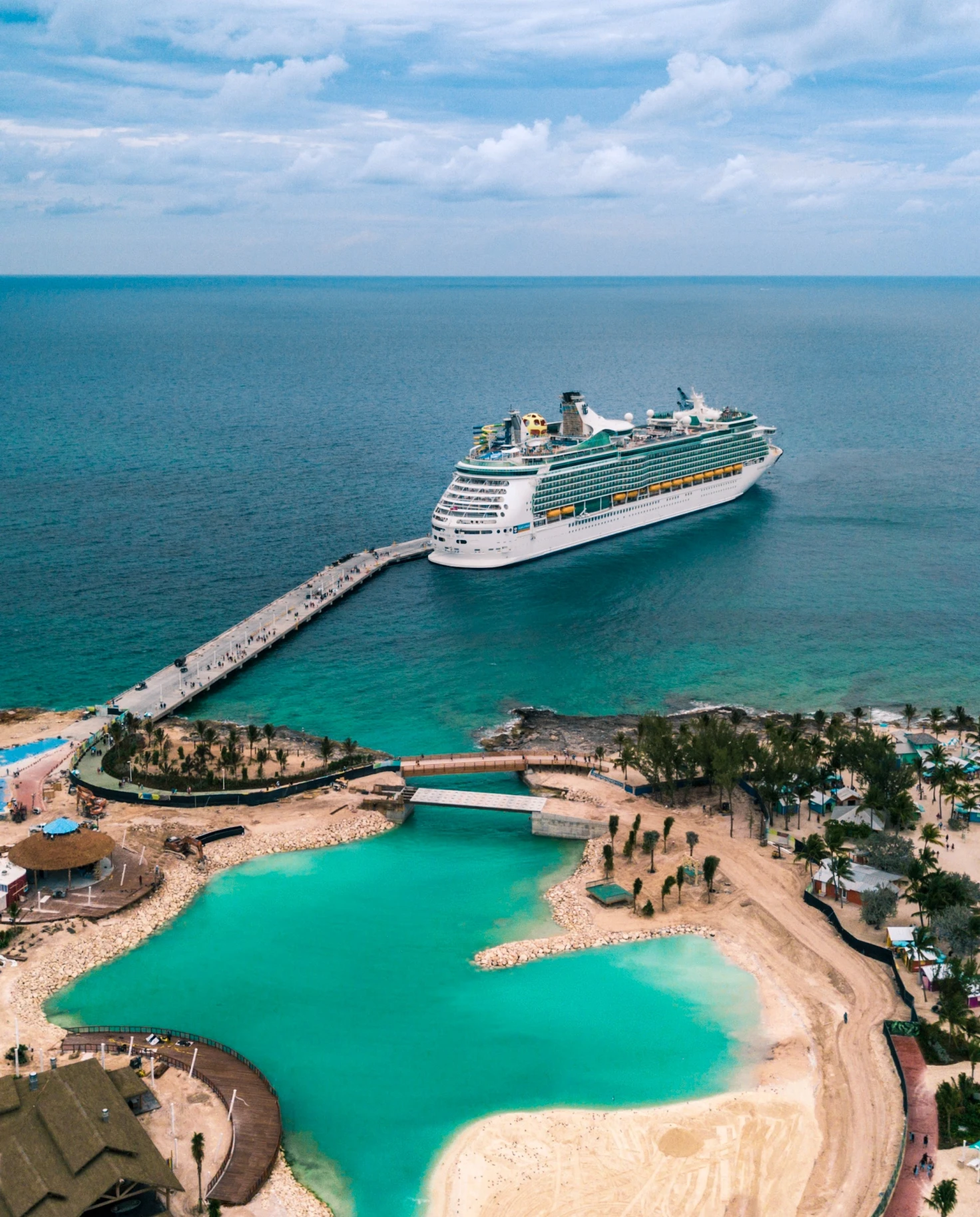 cruise ship in water next to land during daytime