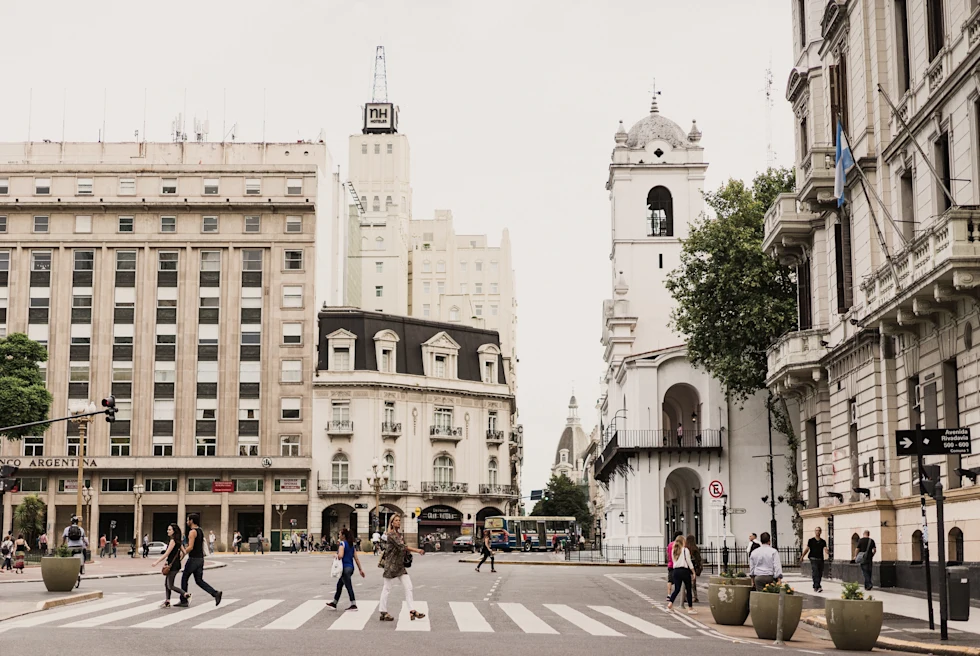 people walking in the street near tall buildings