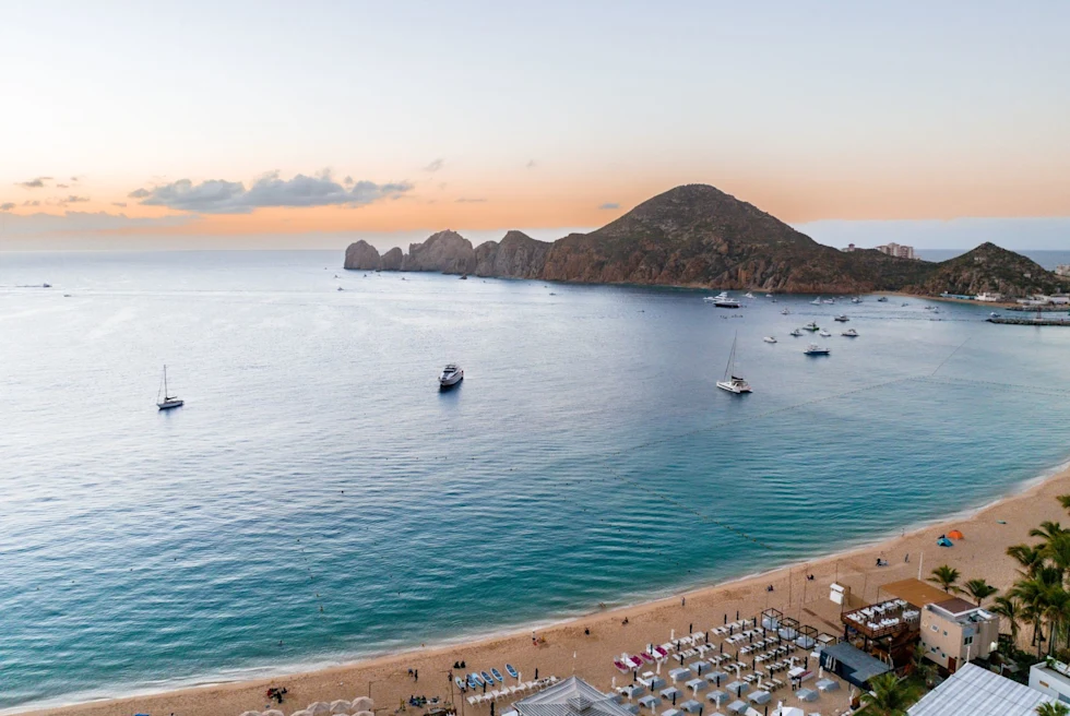 view from the sky of a tropical island with beach chair and umbrellas