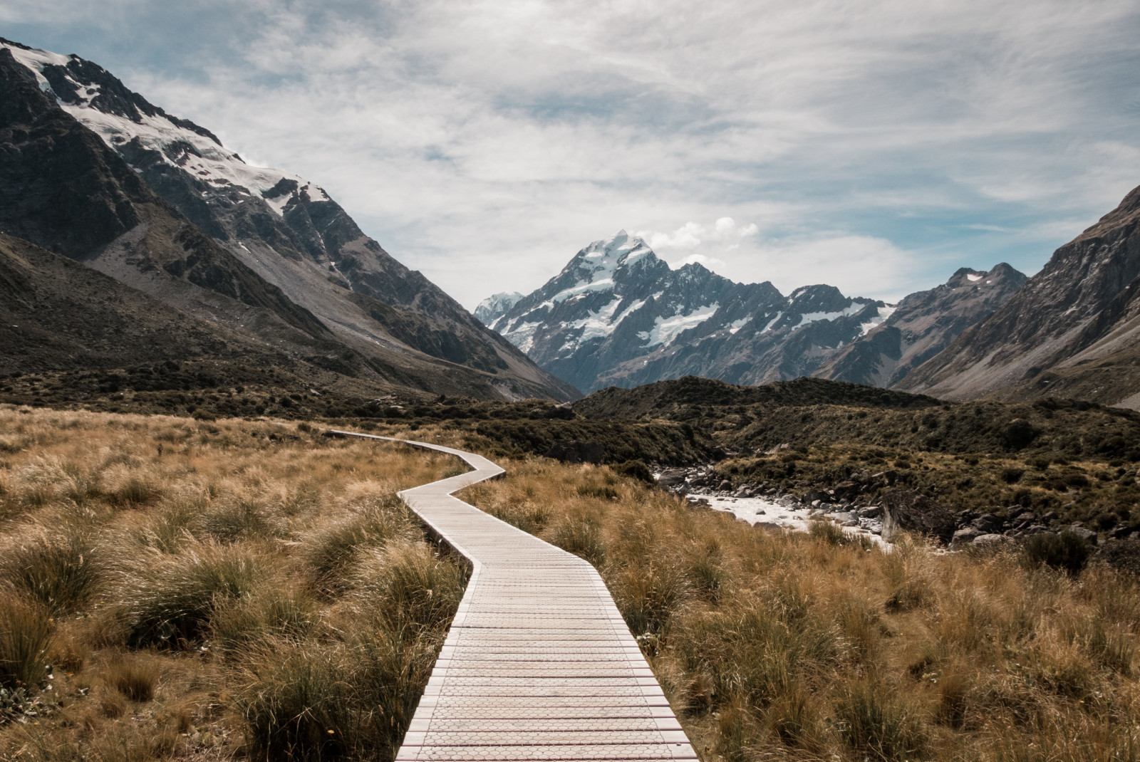 Boardwalk leading through mountain range in New Zealand