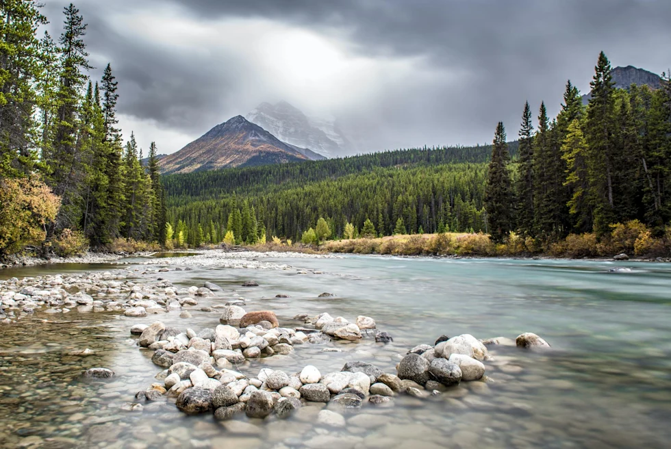Lake surrounded by mountains and trees.