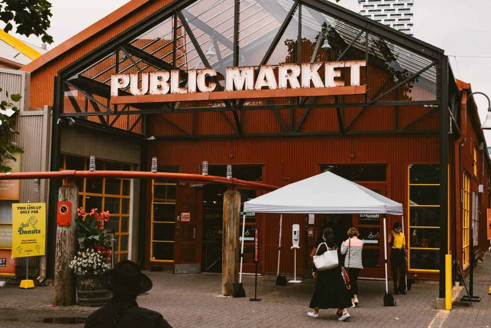 entrance to a market with a sign that reads, "public market".