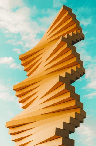 orange abstract sculpture against a blue sky