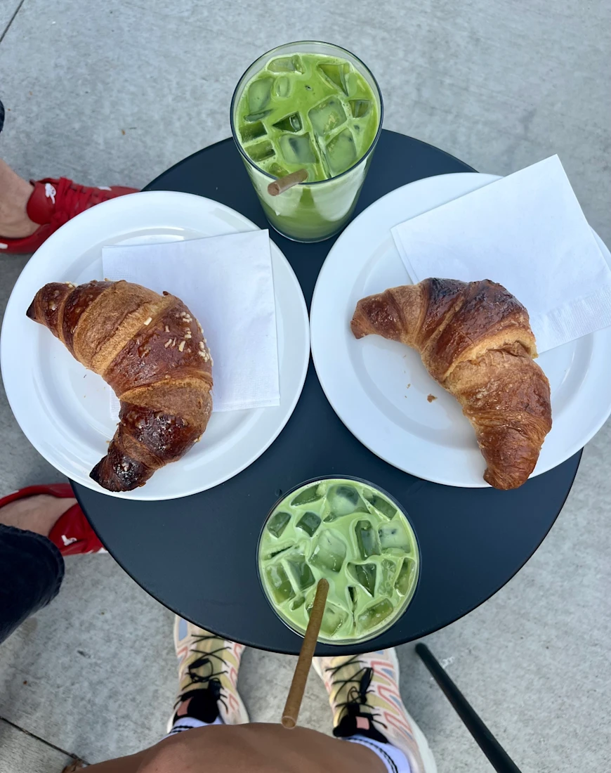 aerial view of croissants and green drinks