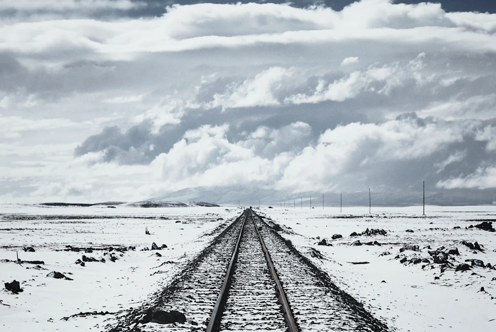 Ground and railway track covered with snow.