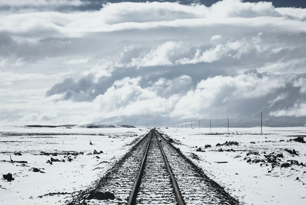 Ground and railway track covered with snow.