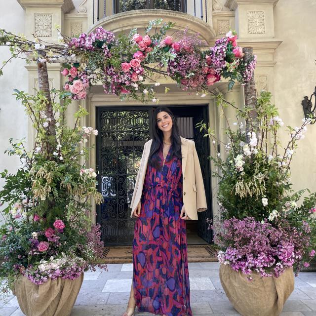 Fora travel advisor Liza Goncharov wearing purple dress standing next to flower pots during daytime