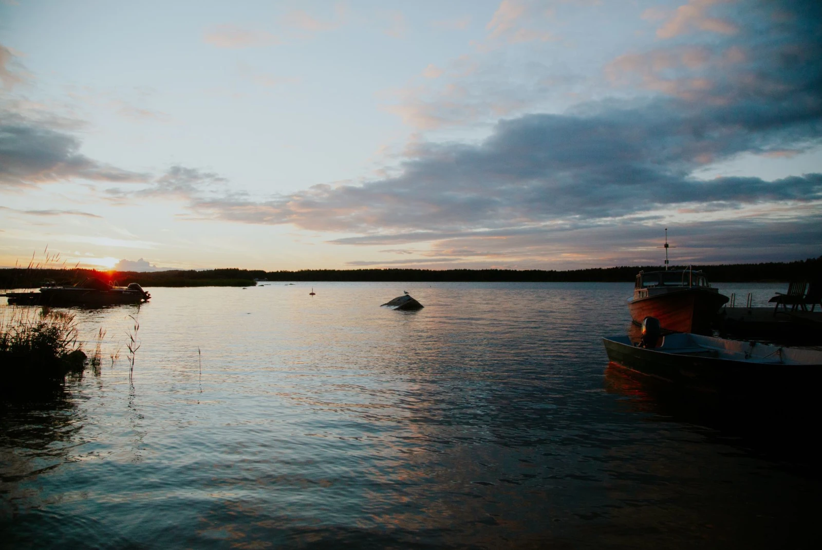 small old motor boat on calm waters at sunset