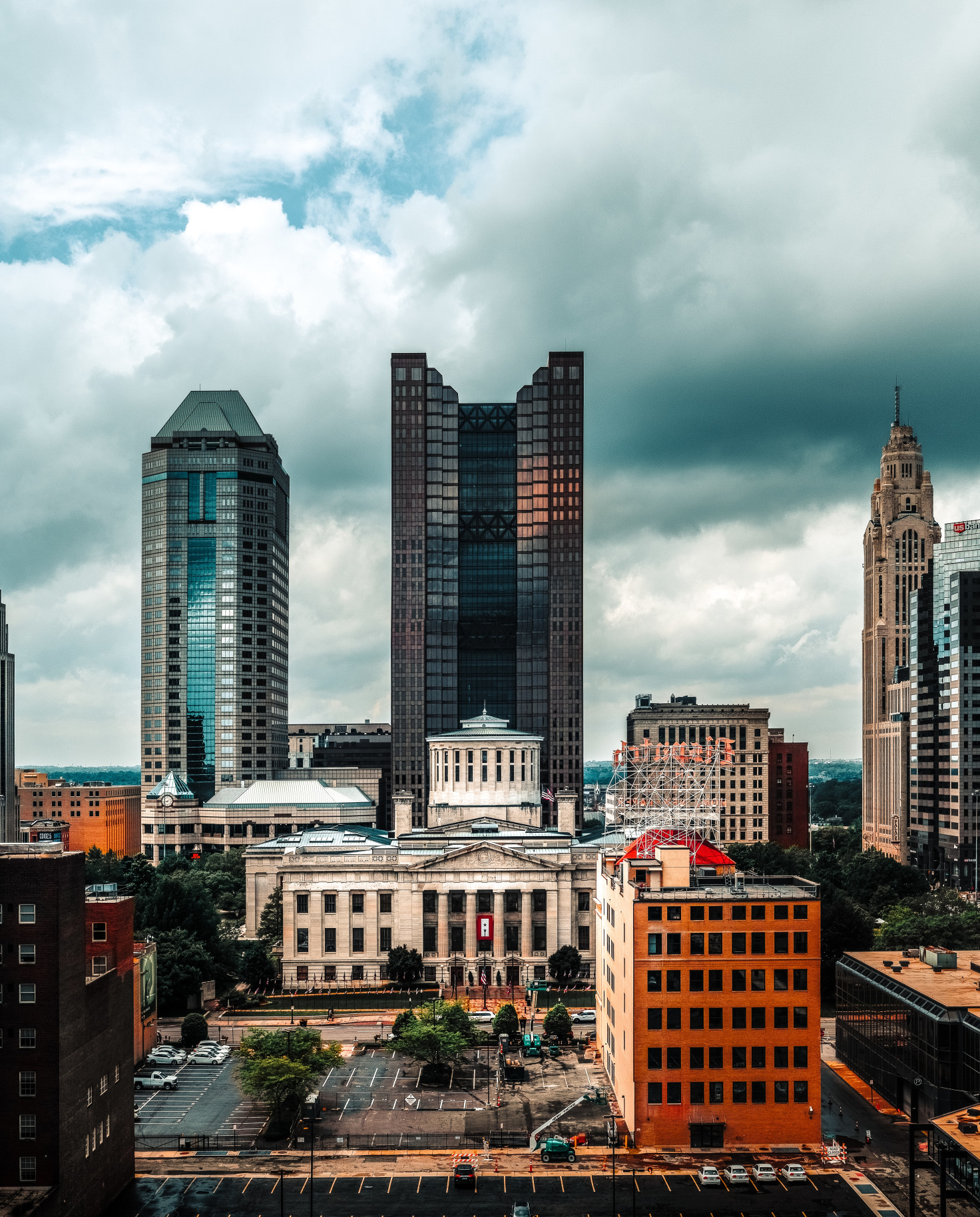 Tall city buildings with cloudy skies during daytime