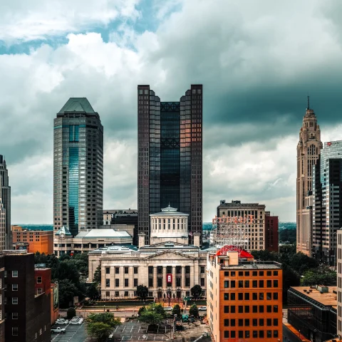 Tall city buildings with cloudy skies during daytime