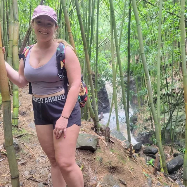 Travel Advisor Jaci Brown hiking with a grey tank top, shorts and a p-cap.  