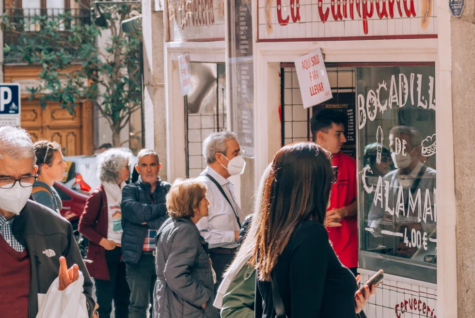 people lining up in front of a food window