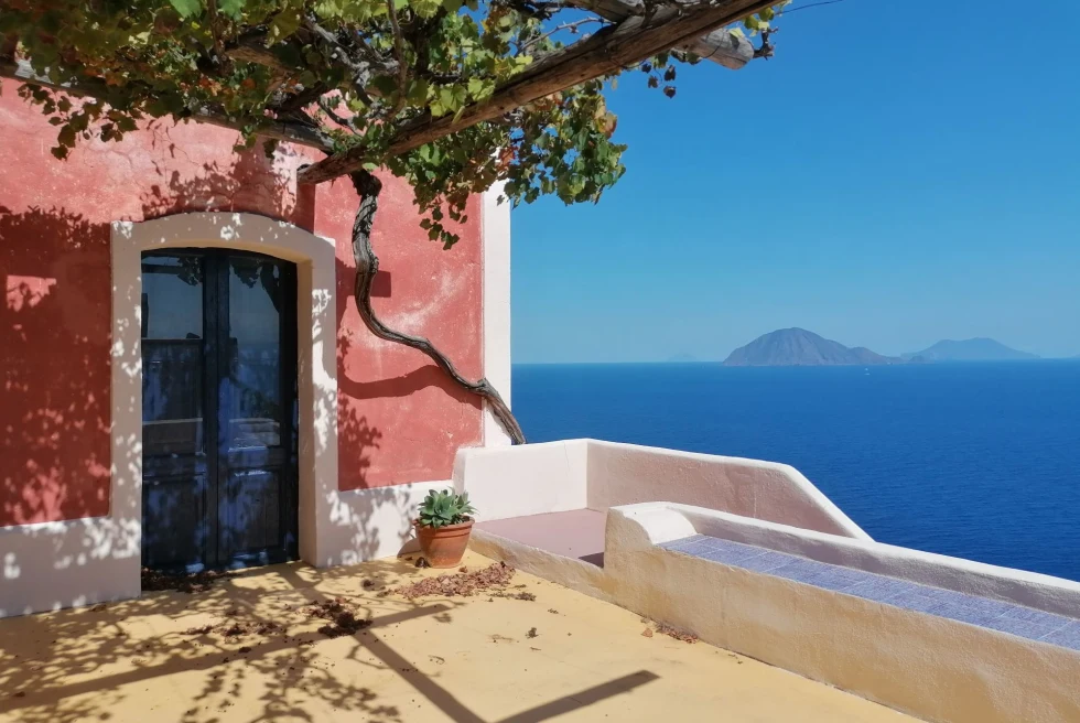 pink building with a tree on an island