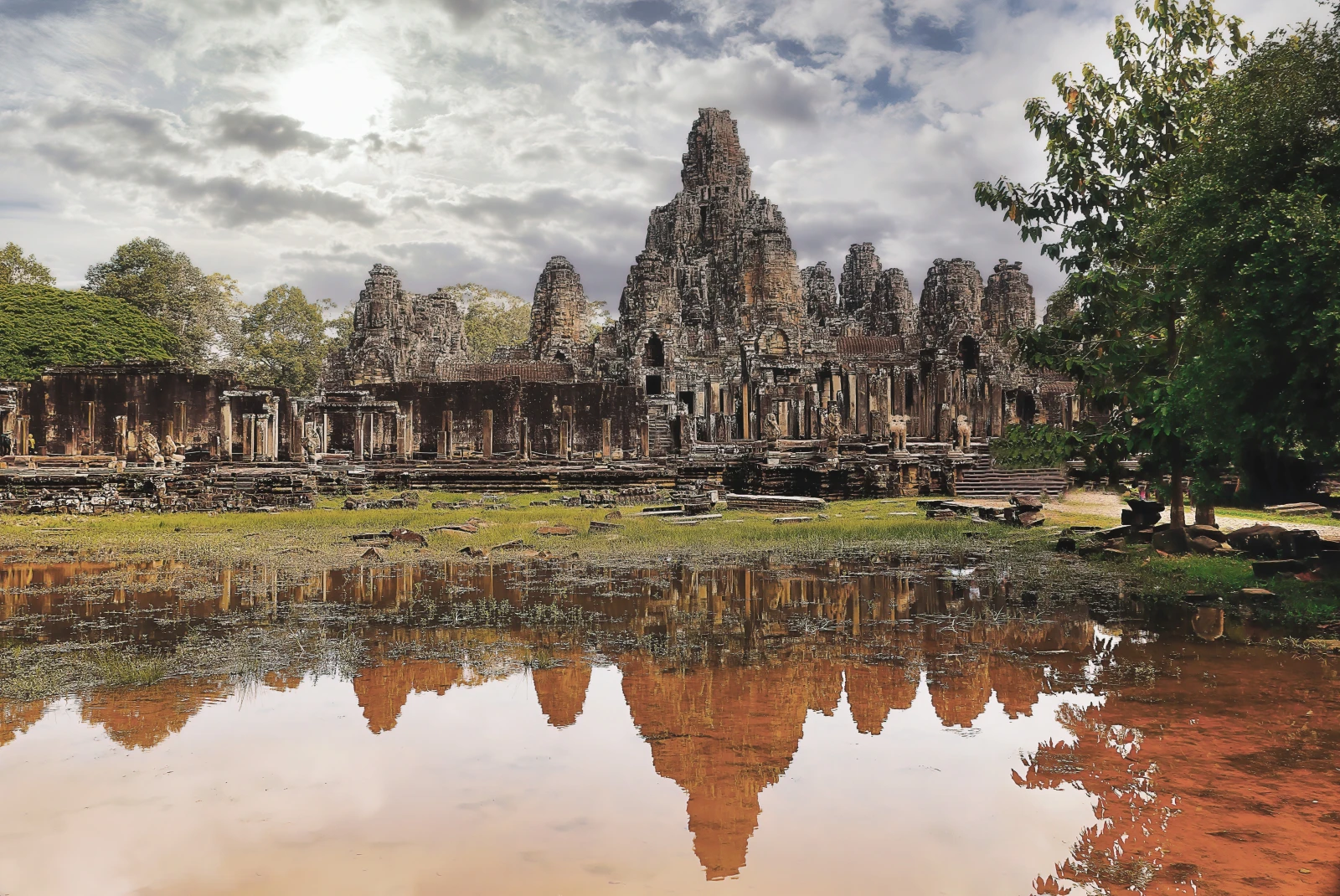 The old Bayon Temple in Cambodia with reflection in lake. 
