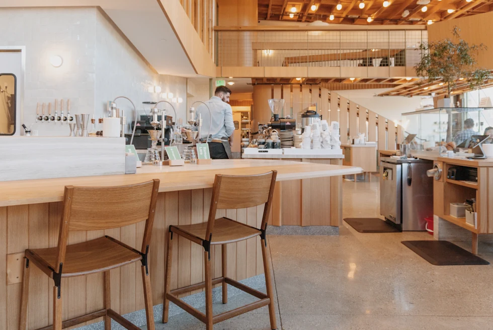 A restaurant with white and light brown interior.