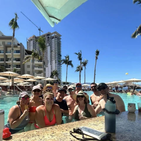 Group of people posing in a pool